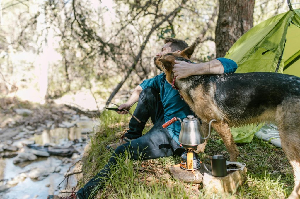 trekking a man sitting next to a dog